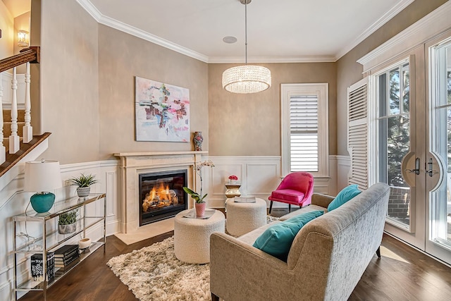 living room with stairs, dark wood-style floors, a fireplace, and ornamental molding