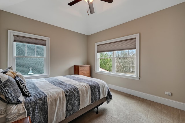 bedroom featuring baseboards, carpet floors, lofted ceiling, and a ceiling fan