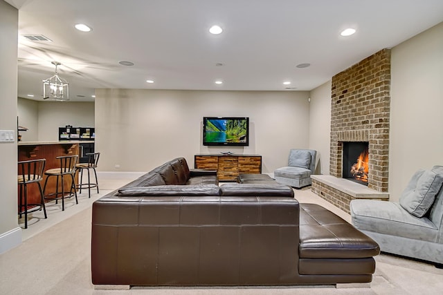 living room with visible vents, a brick fireplace, baseboards, light colored carpet, and recessed lighting