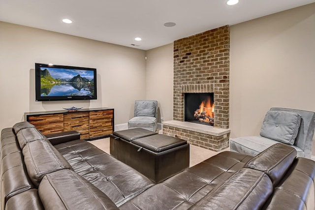 living room with recessed lighting, a brick fireplace, and baseboards