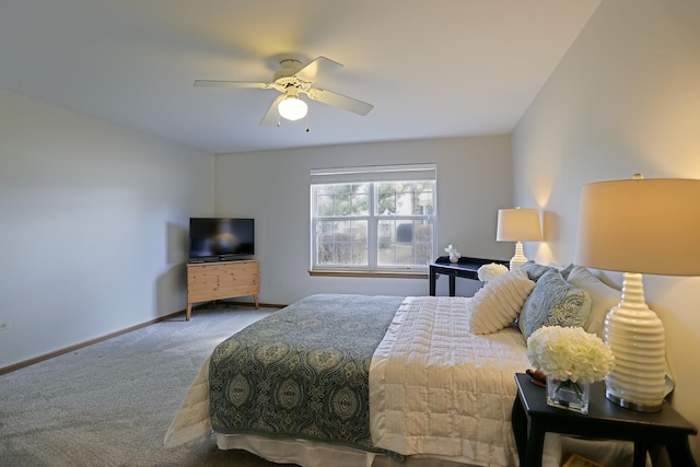 carpeted bedroom with ceiling fan and baseboards