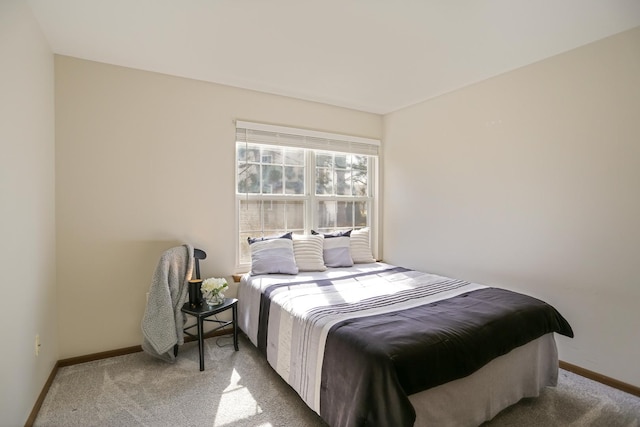 bedroom featuring carpet and baseboards