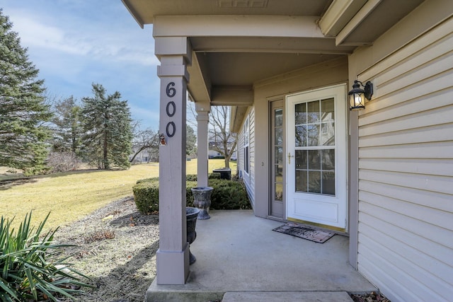 view of exterior entry featuring a yard