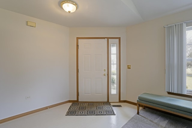 foyer featuring baseboards