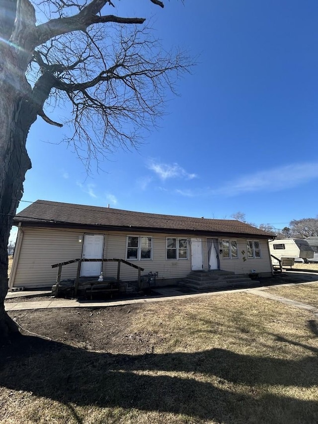 rear view of property with entry steps