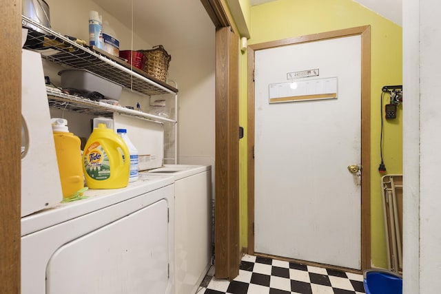 clothes washing area featuring light floors and separate washer and dryer