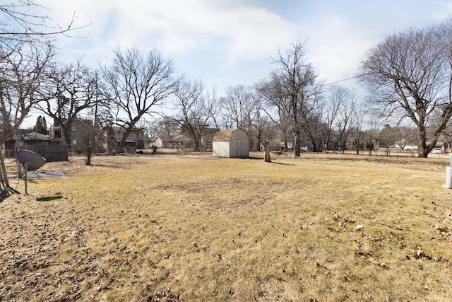 view of yard with a storage shed and an outbuilding