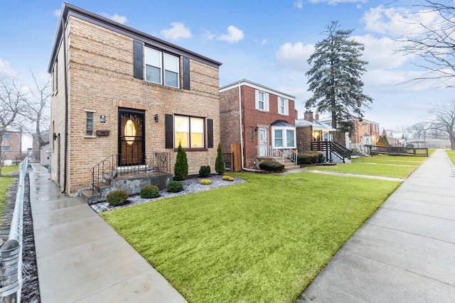 view of front of home featuring a front lawn and brick siding