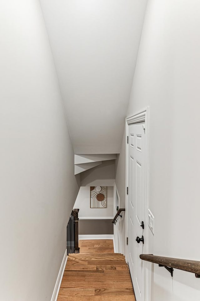 stairs featuring baseboards and wood finished floors