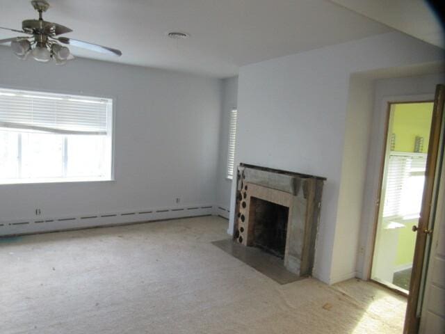 unfurnished living room with carpet floors, ceiling fan, a fireplace with flush hearth, and baseboard heating