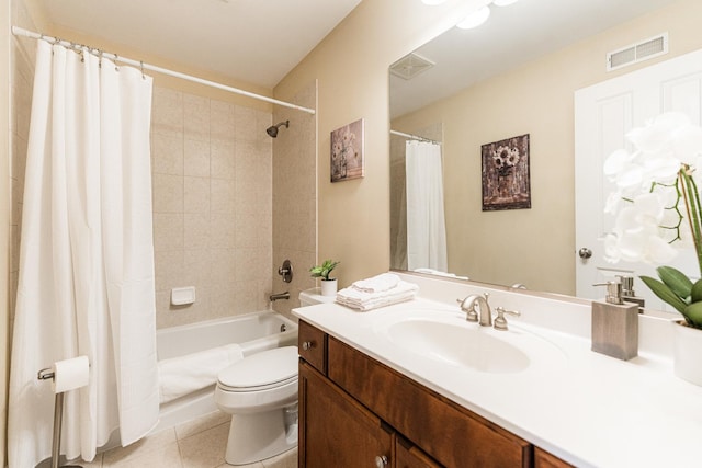 bathroom featuring visible vents, shower / bath combo with shower curtain, toilet, tile patterned flooring, and vanity