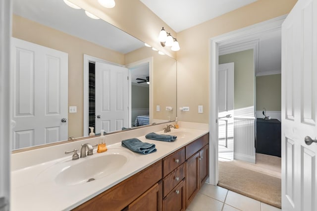 bathroom featuring a sink, double vanity, and tile patterned floors