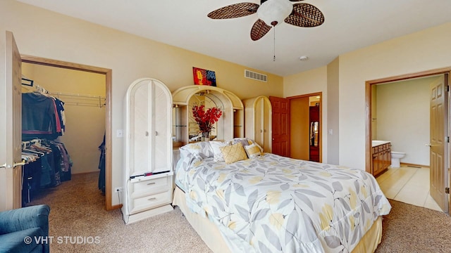 bedroom featuring visible vents, light colored carpet, ceiling fan, a spacious closet, and a closet