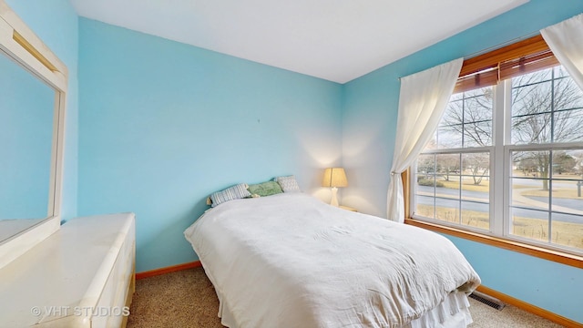 carpeted bedroom with baseboards and visible vents