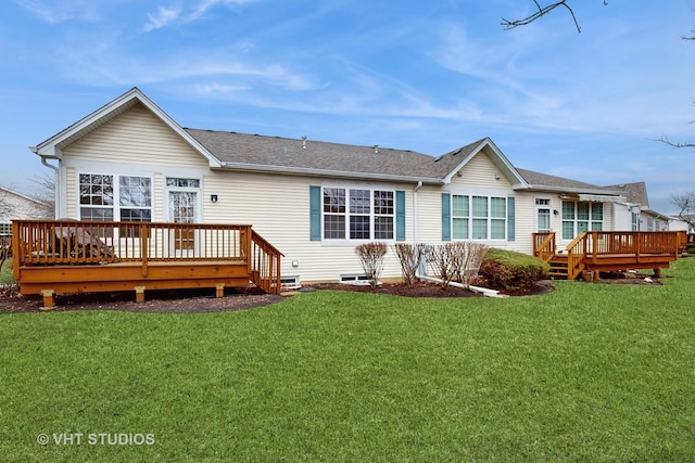 back of property featuring roof with shingles, a yard, and a wooden deck