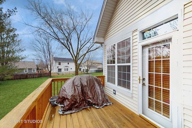 deck featuring a yard, fence, and a residential view