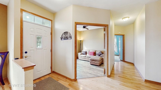 entryway featuring baseboards and light wood finished floors