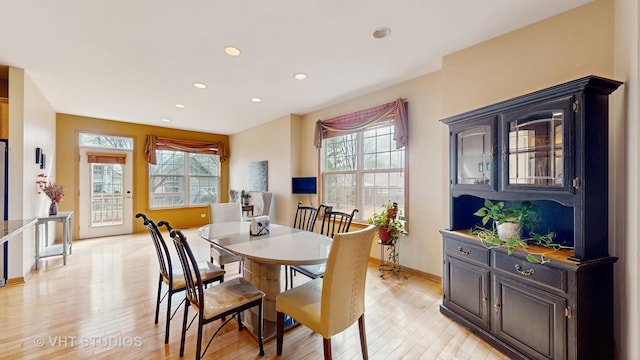 dining area with recessed lighting, a healthy amount of sunlight, light wood-style flooring, and baseboards