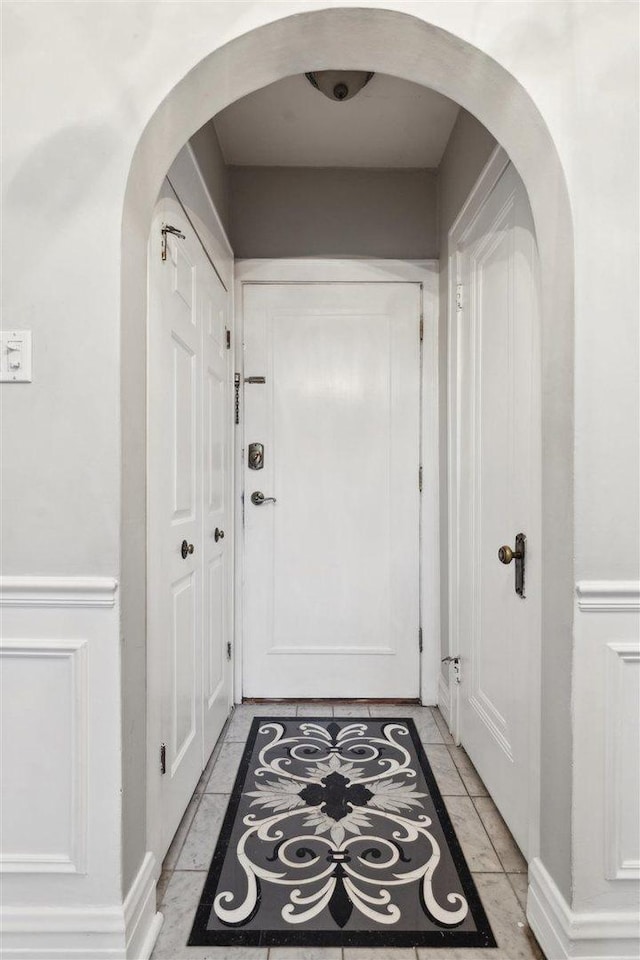 doorway to outside featuring arched walkways