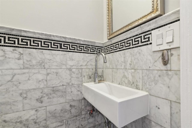 bathroom with a sink and tile walls