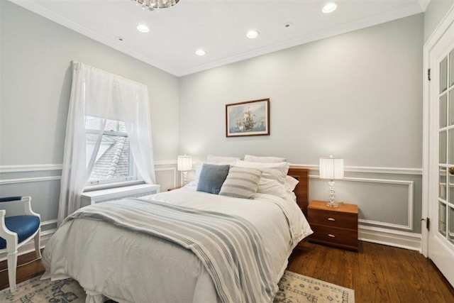 bedroom with ornamental molding, wood finished floors, and recessed lighting