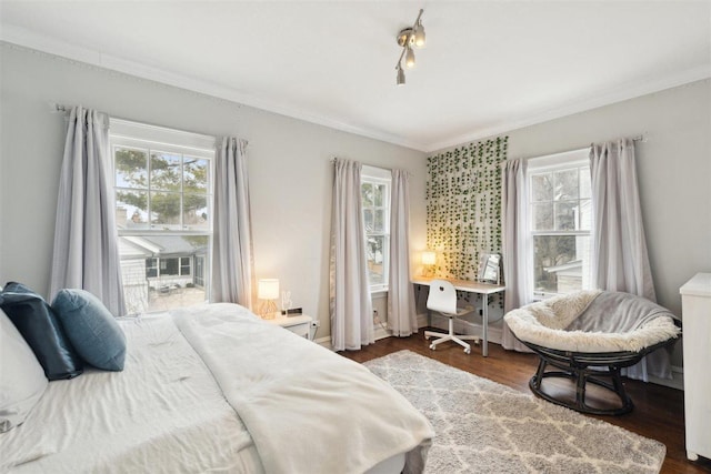 bedroom featuring dark wood-style floors, multiple windows, and crown molding