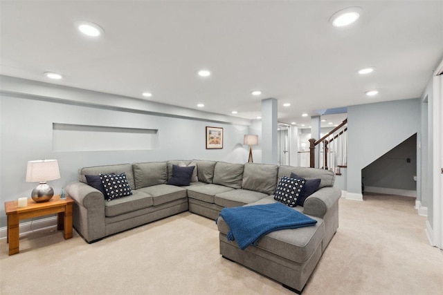 living area featuring light carpet, stairway, and recessed lighting