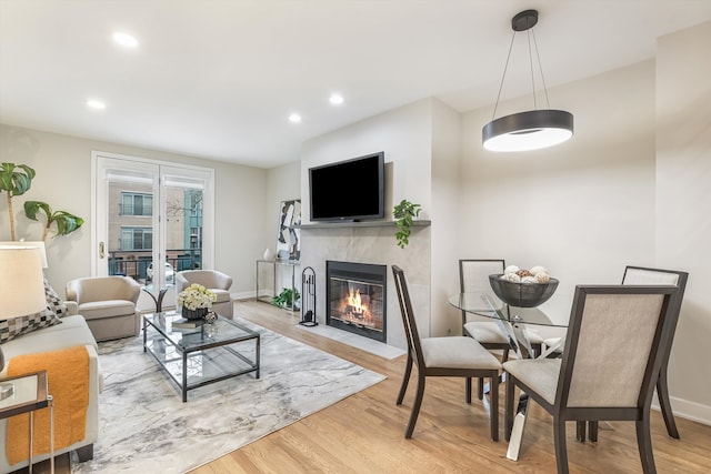 living room with recessed lighting, a fireplace, wood finished floors, and baseboards