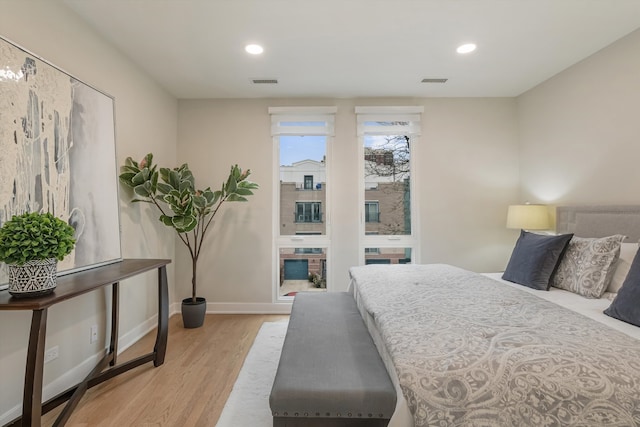 bedroom featuring baseboards, recessed lighting, visible vents, and light wood-style floors