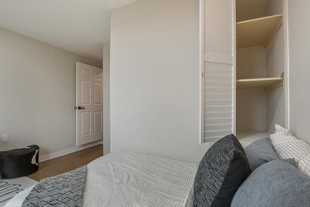 bedroom featuring wood finished floors and baseboards