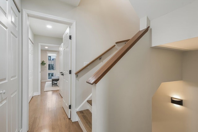 stairway with baseboards and wood finished floors