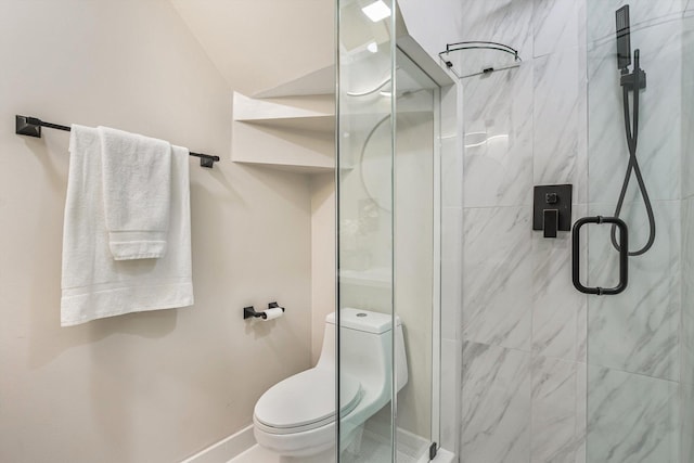 bathroom with a stall shower, toilet, and baseboards