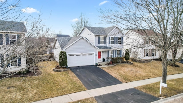 traditional-style home featuring aphalt driveway, a front yard, a shingled roof, and a garage