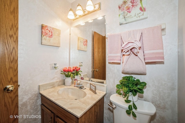 half bath with vanity and toilet