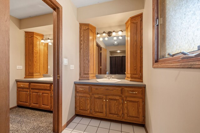 full bath featuring tile patterned flooring, vanity, and baseboards