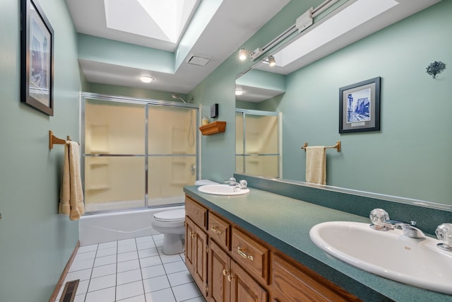 full bathroom with a skylight, tile patterned flooring, visible vents, and a sink