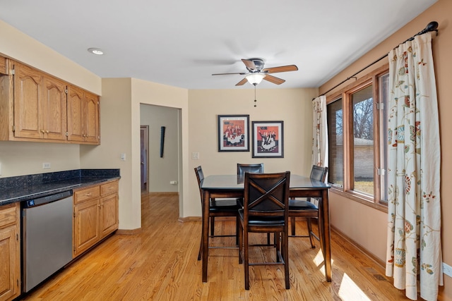 dining room with light wood-style floors, baseboards, and a ceiling fan