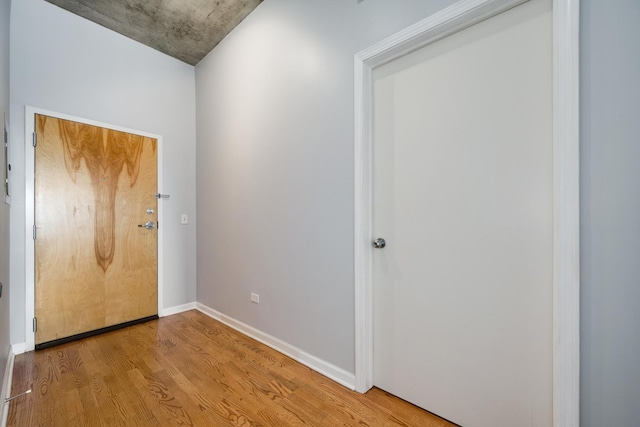 entryway with wood finished floors and baseboards