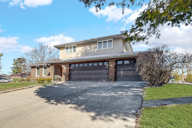 view of front of property with brick siding, driveway, and a garage