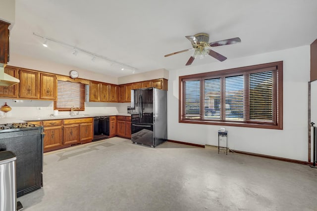 kitchen featuring a ceiling fan, baseboards, black appliances, exhaust hood, and brown cabinets