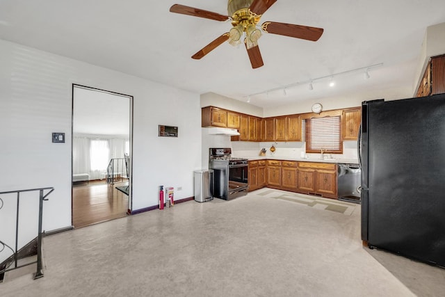 kitchen featuring freestanding refrigerator, ceiling fan, a sink, dishwasher, and gas range