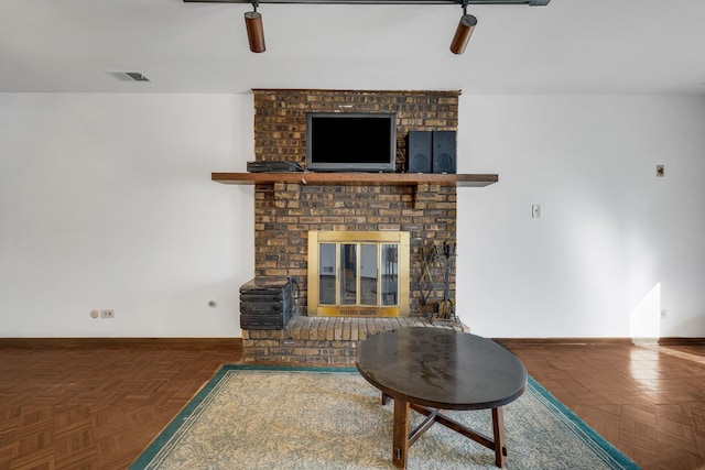 living area with visible vents, baseboards, ceiling fan, and a fireplace