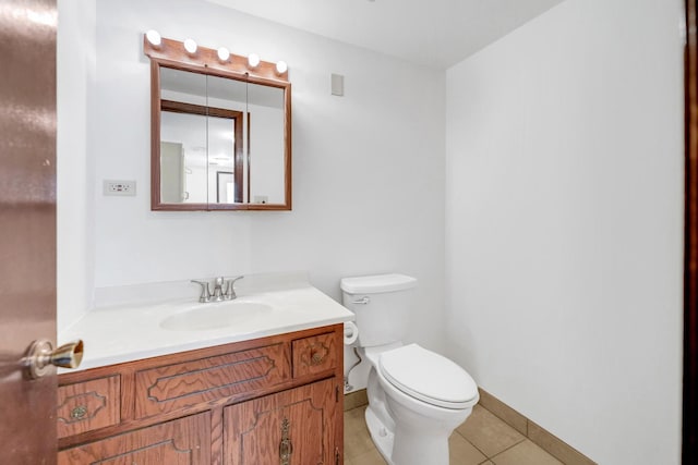 bathroom with tile patterned floors, toilet, vanity, and baseboards