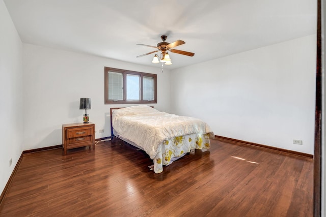 bedroom with baseboards, dark wood-type flooring, and a ceiling fan