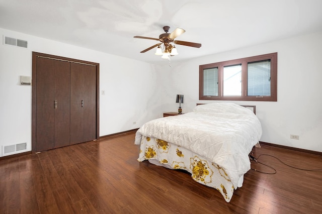 bedroom with wood finished floors, visible vents, and baseboards