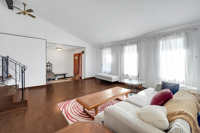 living room featuring lofted ceiling, wood finished floors, baseboards, and ceiling fan