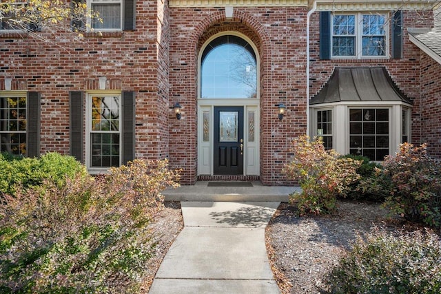 doorway to property with brick siding