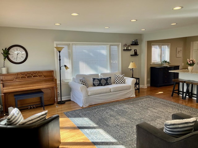 living room with light wood-style flooring, baseboards, and recessed lighting