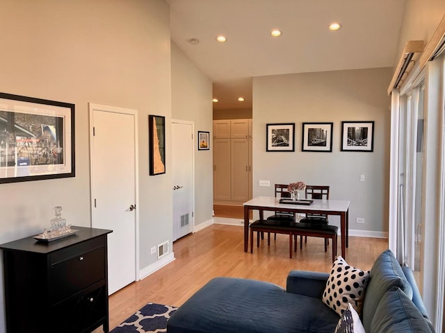 living room with baseboards, recessed lighting, and light wood-style floors