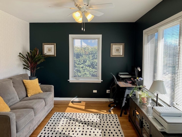 home office with ceiling fan, wood finished floors, and baseboards